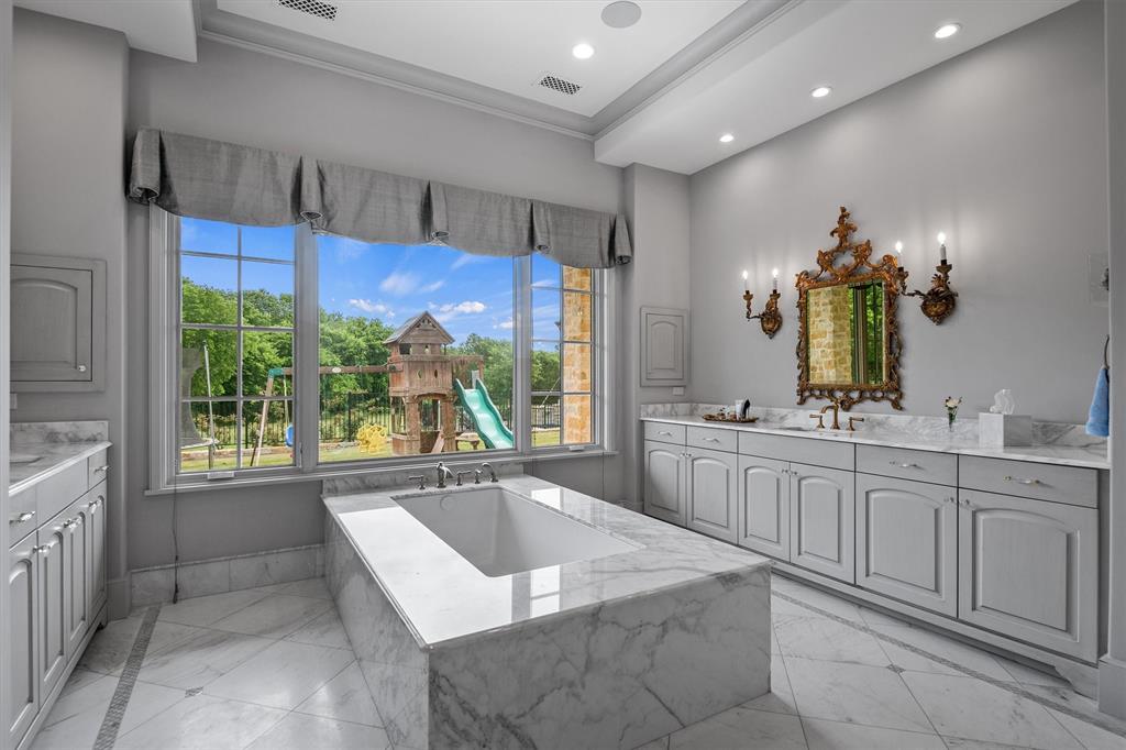 4101 Howard Road Waxahachie, TX 75165 - Photo 19 of 40 Step inside the most luxurious marble encased bathtub surrounded by natural light.