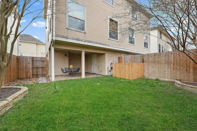 a backyard of a house with table and chairs