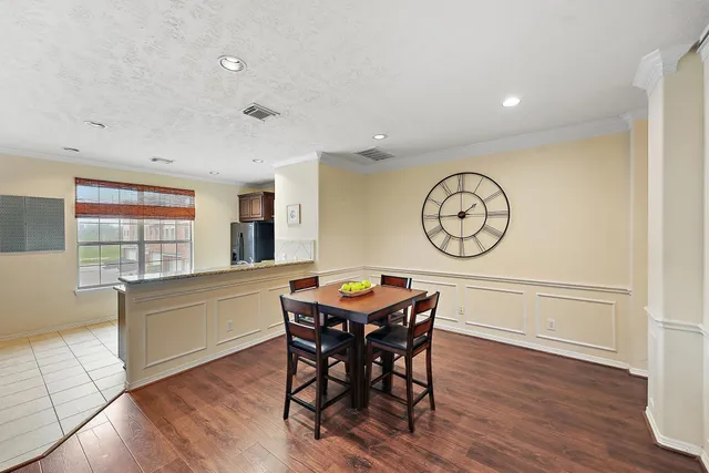 a view of a dining room with furniture window and wooden floor
