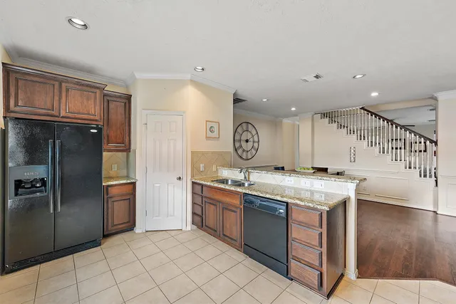 a kitchen with a sink and refrigerator