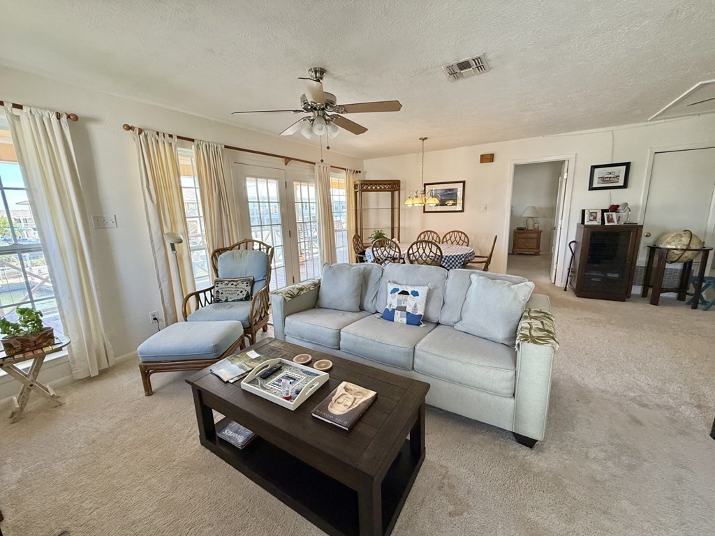 30 Flamingo Road Rockport, TX 78382 - Photo 16 of 39 a living room with furniture a ceiling fan and a window