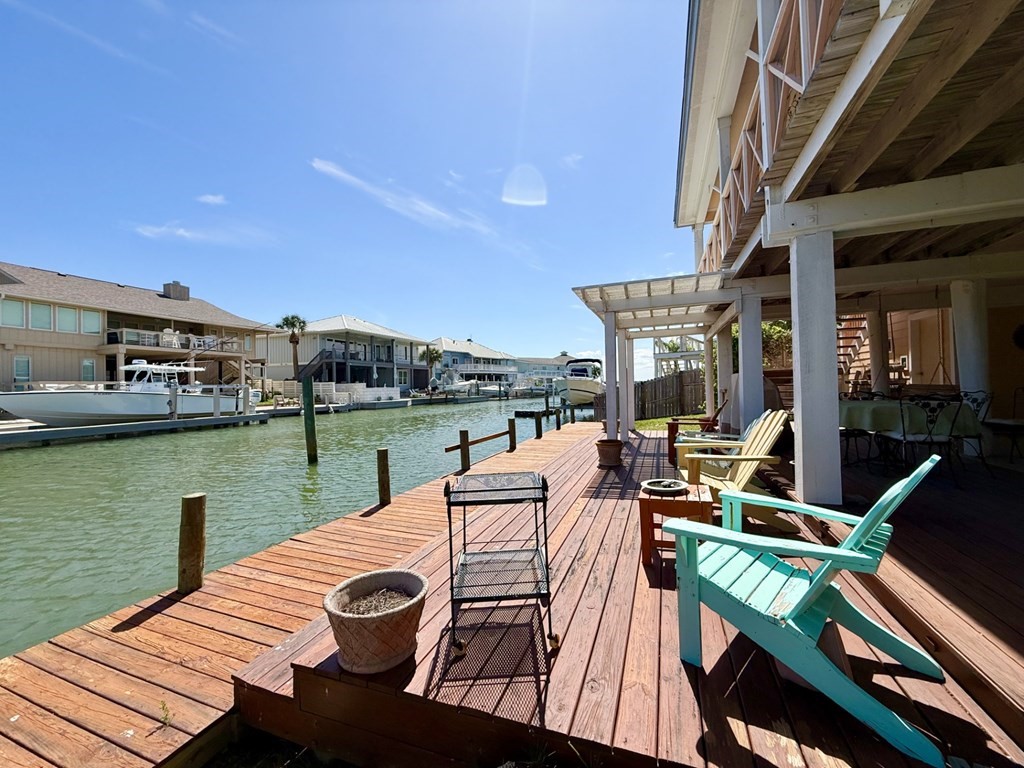 30 Flamingo Road Rockport, TX 78382 - Photo 4 of 39 a view of a lake with couches chairs on the deck