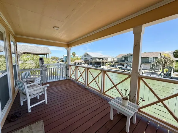 a view of a balcony with furniture and wooden floor