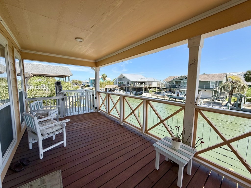 30 Flamingo Road Rockport, TX 78382 - Photo 7 of 39 a view of a balcony with furniture and wooden floor