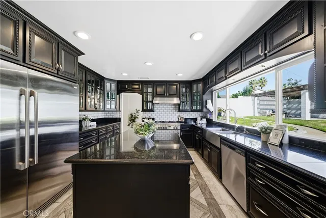a dining room with furniture and a floor to ceiling window