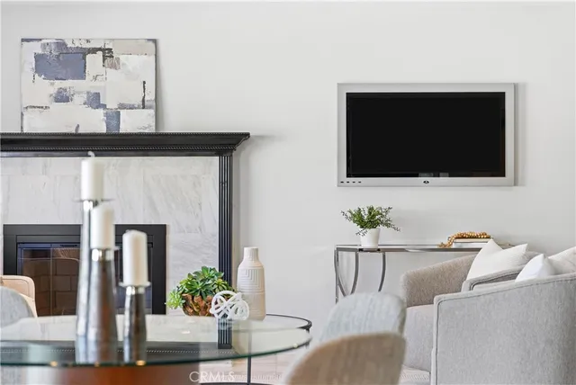 a living room with furniture a flat screen tv and a fireplace