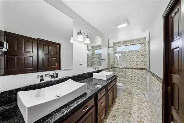 a kitchen with stainless steel appliances granite countertop a refrigerator and a stove