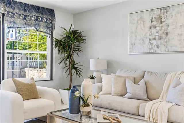 a living room with furniture and floor to ceiling windows