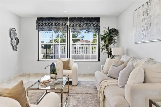a living room with furniture and view of kitchen