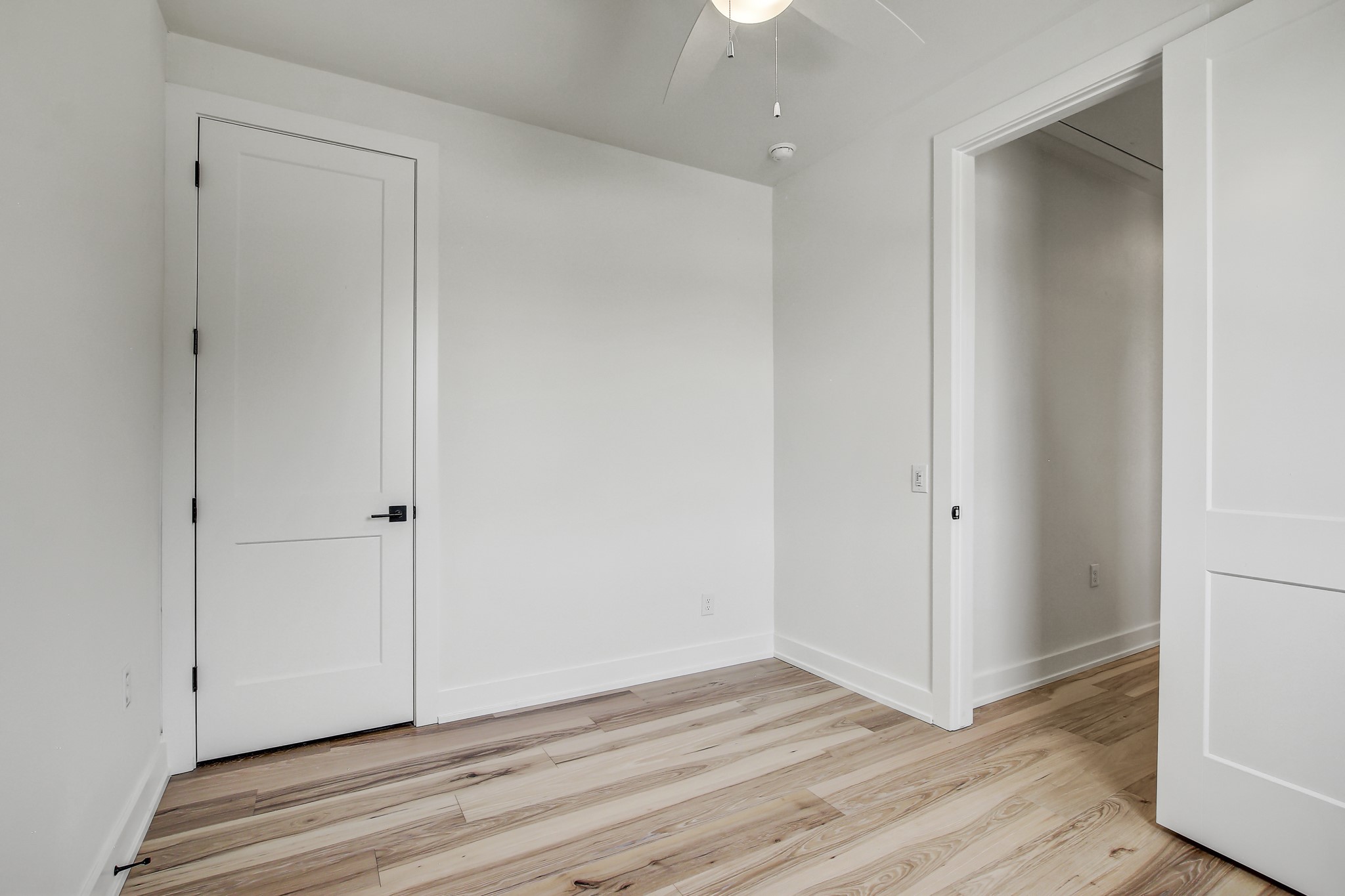 4127 East 12th Street, Unit 4 Austin, TX 78721 - Photo 18 of 32 Unfurnished bedroom with light wood-style floors, baseboards, and ceiling fan