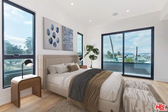 a bedroom with a large bed and a large window