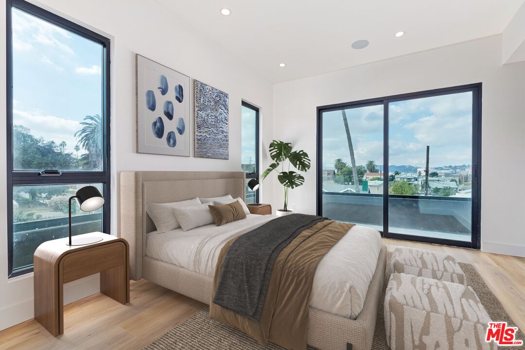 1436 Edgecliffe Drive, Unit 102 Los Angeles, CA 90026 - Photo 11 of 18 a bedroom with a large bed and a large window