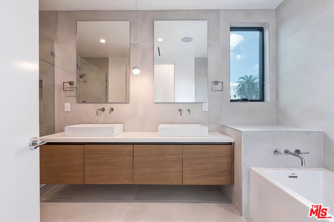 1436 Edgecliffe Drive, Unit 102 Los Angeles, CA 90026 - Photo 12 of 18 a bathroom with a double vanity sink mirror and bathtub