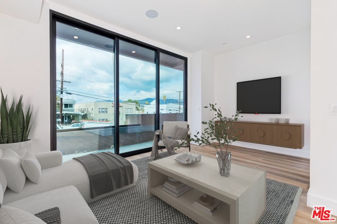 1436 Edgecliffe Drive, Unit 102 Los Angeles, CA 90026 - Photo 15 of 18 a living room with furniture and a flat screen tv