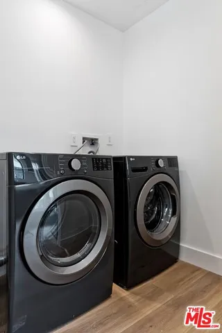 a utility room with sink dryer and washer
