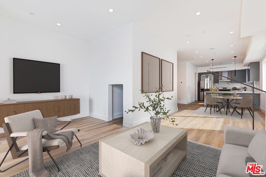 1436 Edgecliffe Drive, Unit 102 Los Angeles, CA 90026 - Photo 3 of 18 a living room with furniture and a flat screen tv