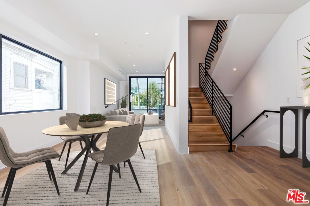 1436 Edgecliffe Drive, Unit 102 Los Angeles, CA 90026 - Photo 5 of 18 a view of a dining room with furniture and wooden floor