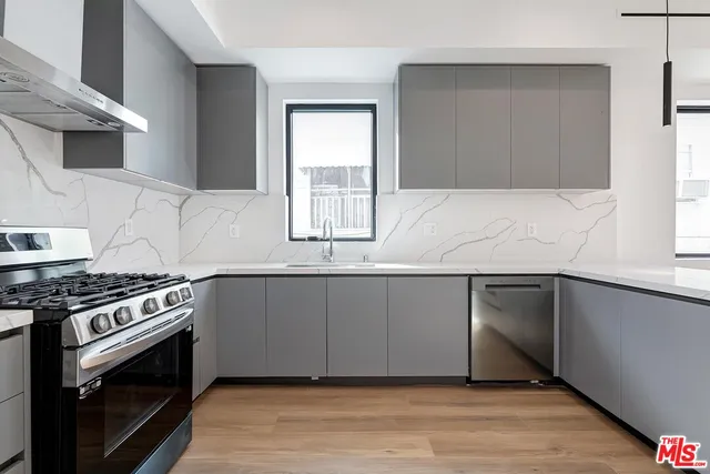 a kitchen with granite countertop a stove and a sink