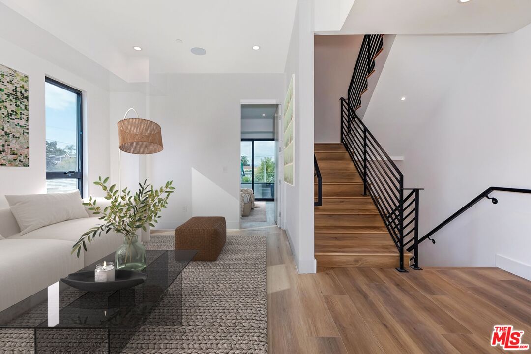 1436 Edgecliffe Drive, Unit 102 Los Angeles, CA 90026 - Photo 8 of 18 a living room with furniture and a wooden floor