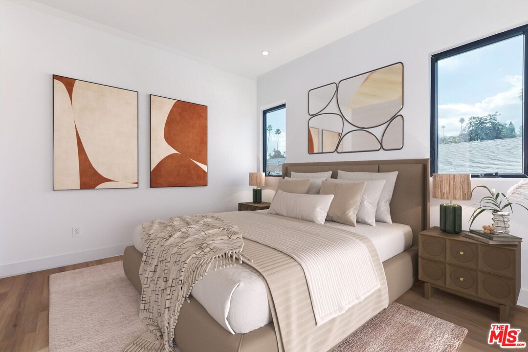 1436 Edgecliffe Drive, Unit 102 Los Angeles, CA 90026 - Photo 10 of 18 a bedroom with a bed and wall painting