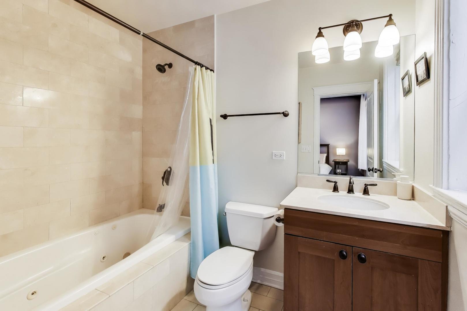 4441 North Beacon Street, Unit 2A Chicago, IL 60640 - Photo 14 of 23 a bathroom with a sink a toilet and shower