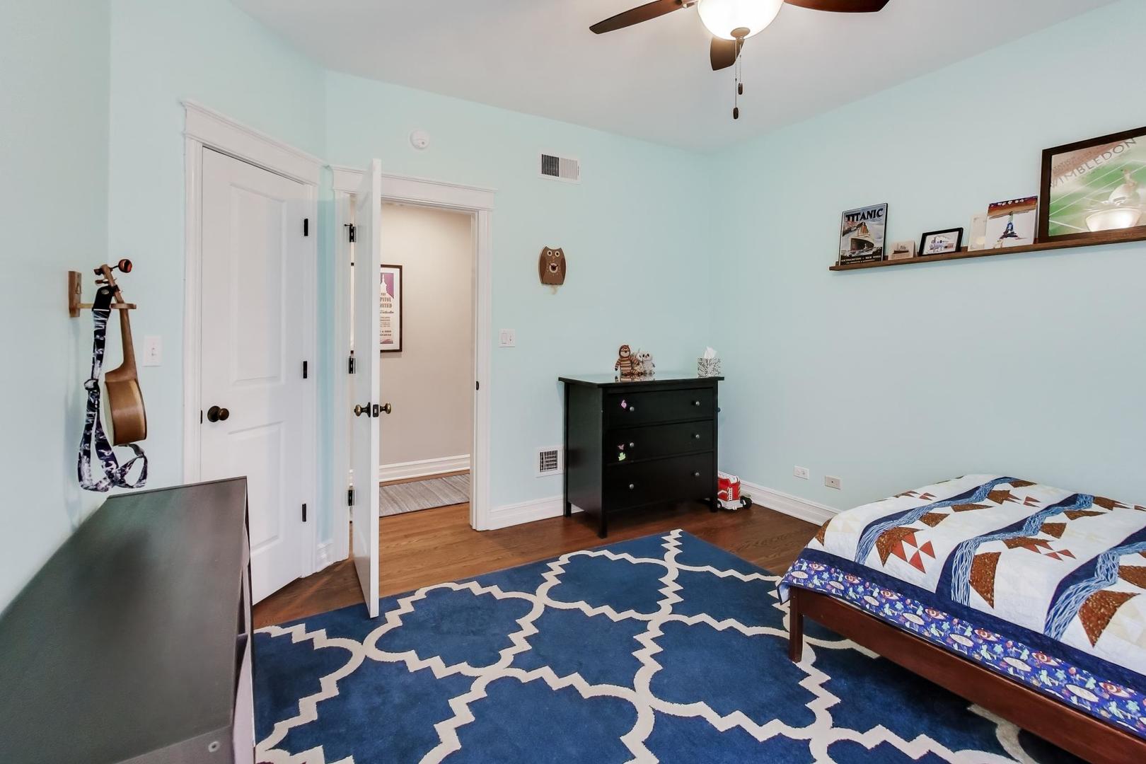 4441 North Beacon Street, Unit 2A Chicago, IL 60640 - Photo 16 of 23 a bedroom with a bed and wooden floor