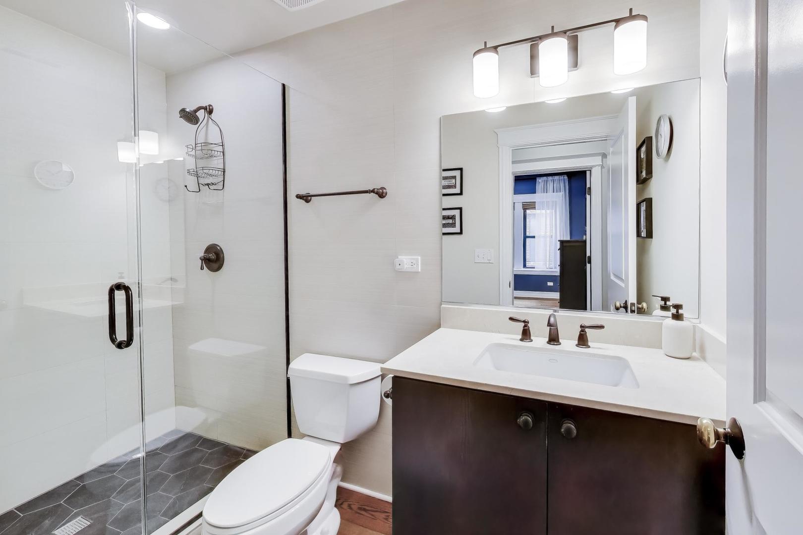 4441 North Beacon Street, Unit 2A Chicago, IL 60640 - Photo 19 of 23 a bathroom with a sink a toilet and shower