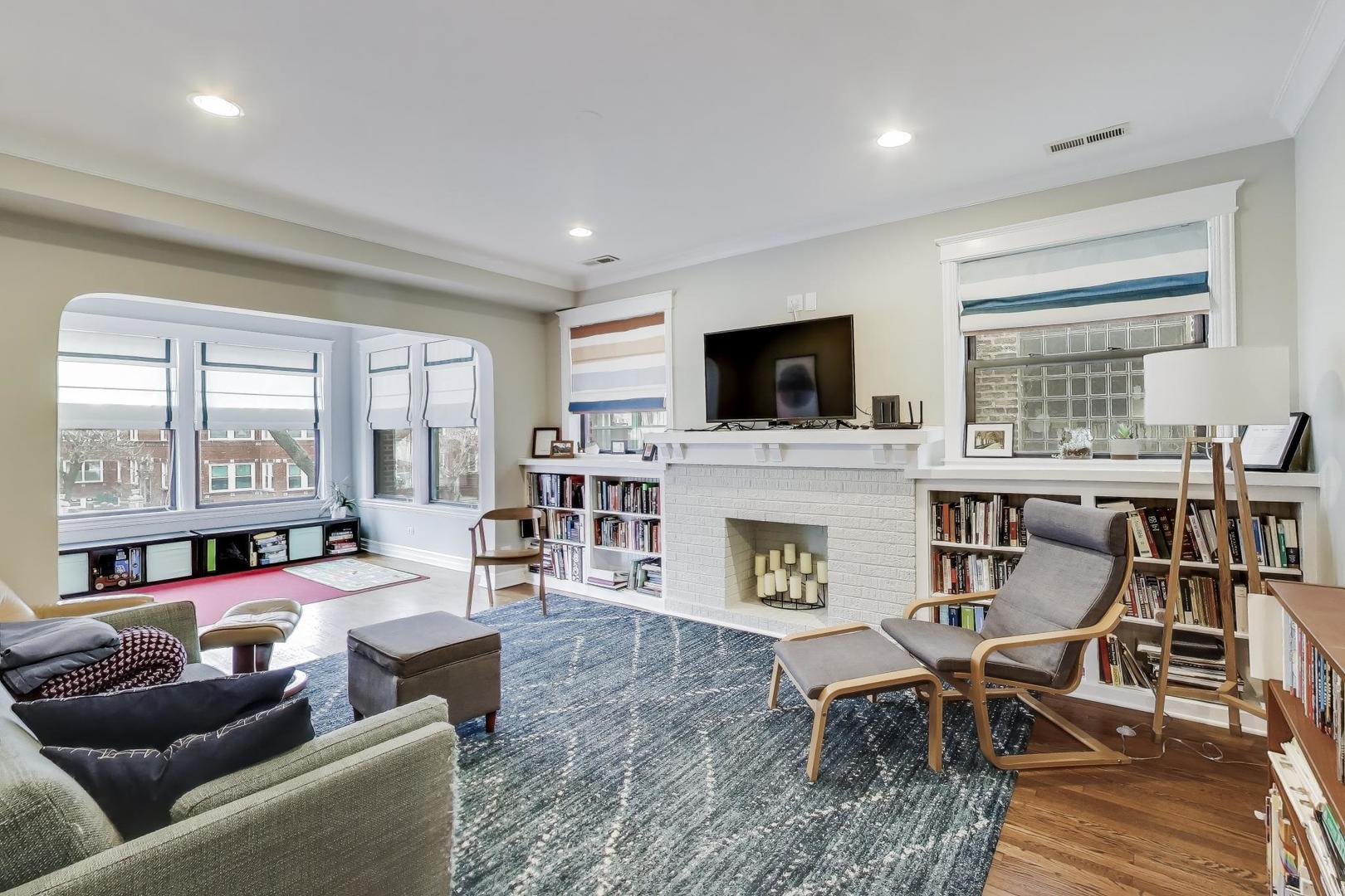 4441 North Beacon Street, Unit 2A Chicago, IL 60640 - Photo 3 of 23 a living room with furniture a fireplace and a flat screen tv
