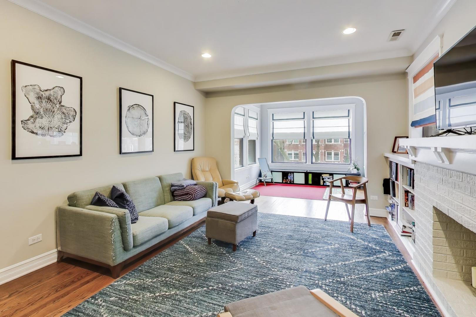 4441 North Beacon Street, Unit 2A Chicago, IL 60640 - Photo 4 of 23 a living room with furniture and a fireplace
