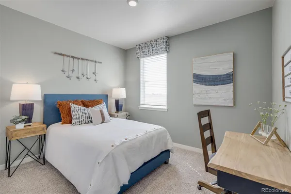 a bedroom with a bed a desk and chair