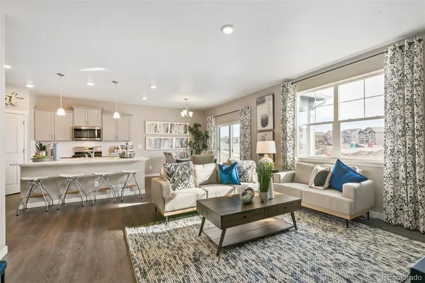 a living room with furniture and a large window