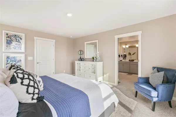 a spacious bedroom with a bed and furniture