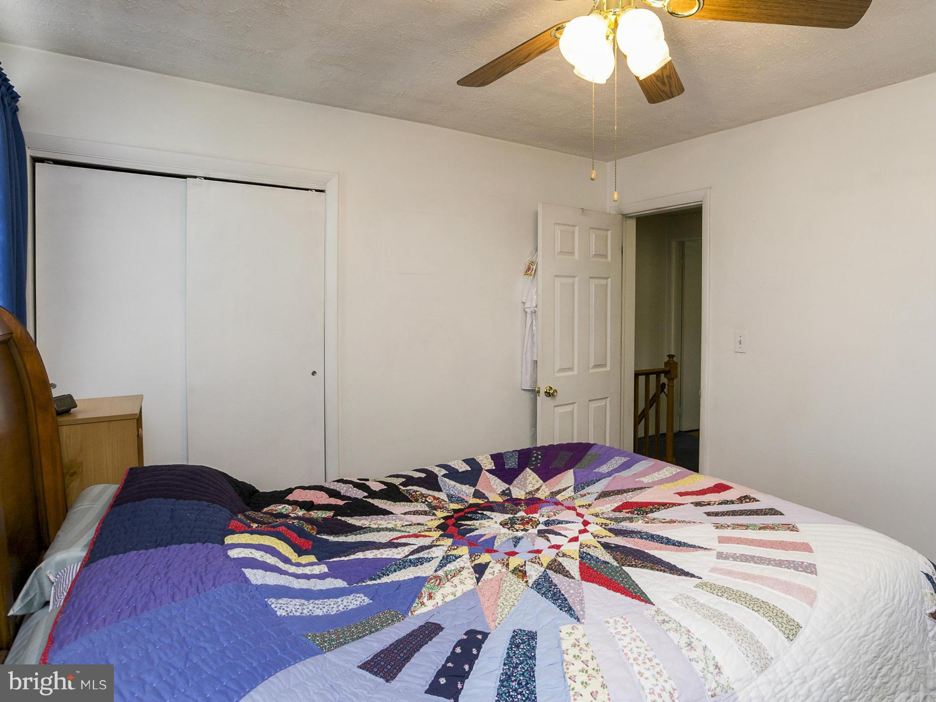 611 Aldworth Road Baltimore, MD 21222 - Photo 14 of 25 a bedroom with a bed and a chandelier