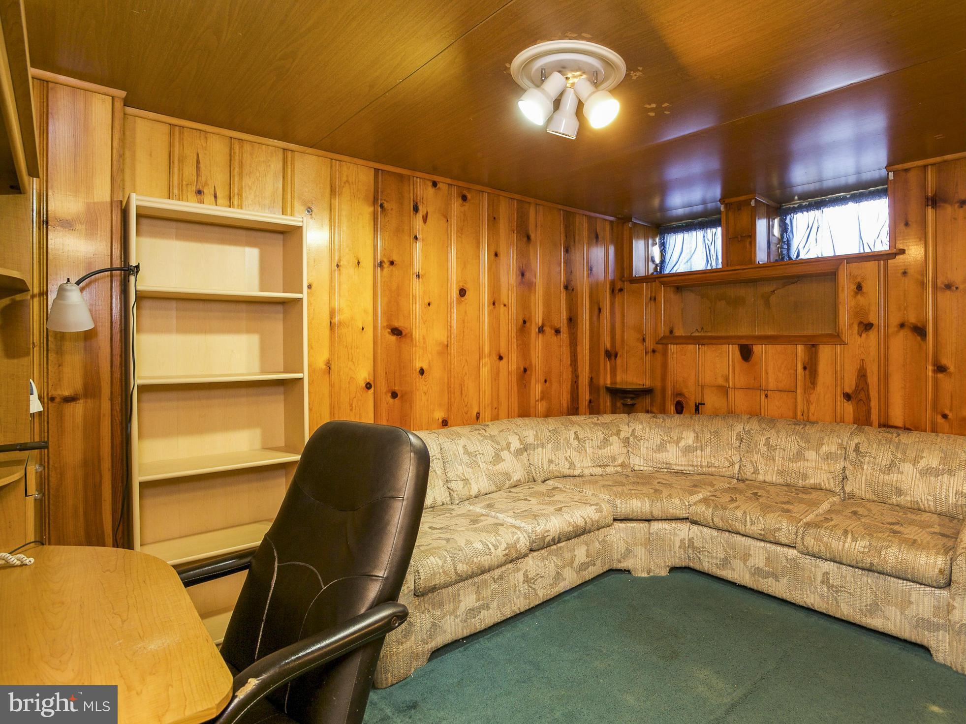 611 Aldworth Road Baltimore, MD 21222 - Photo 22 of 25 a bedroom with a bed and a chair