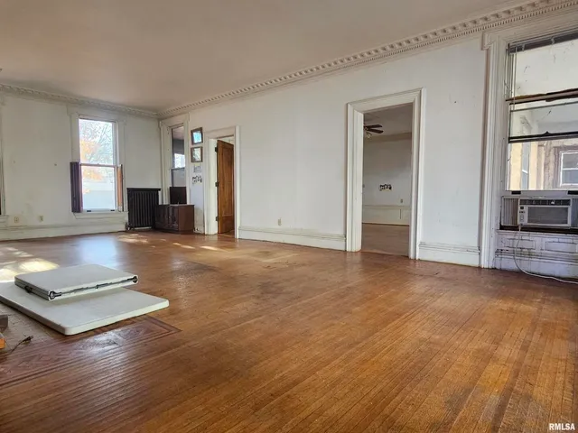 a view of a room with wooden floor and cabinet