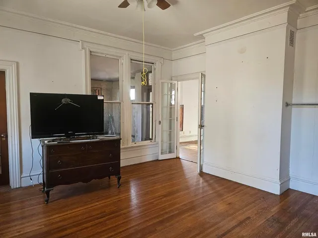 wooden floor in an empty room with a window