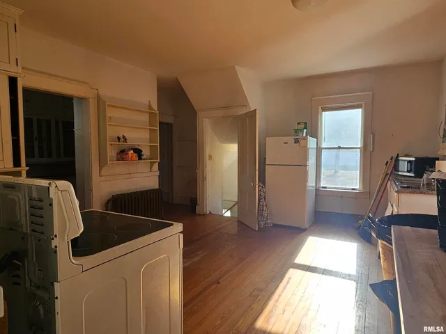 a view of a livingroom with furniture wooden floor and windows