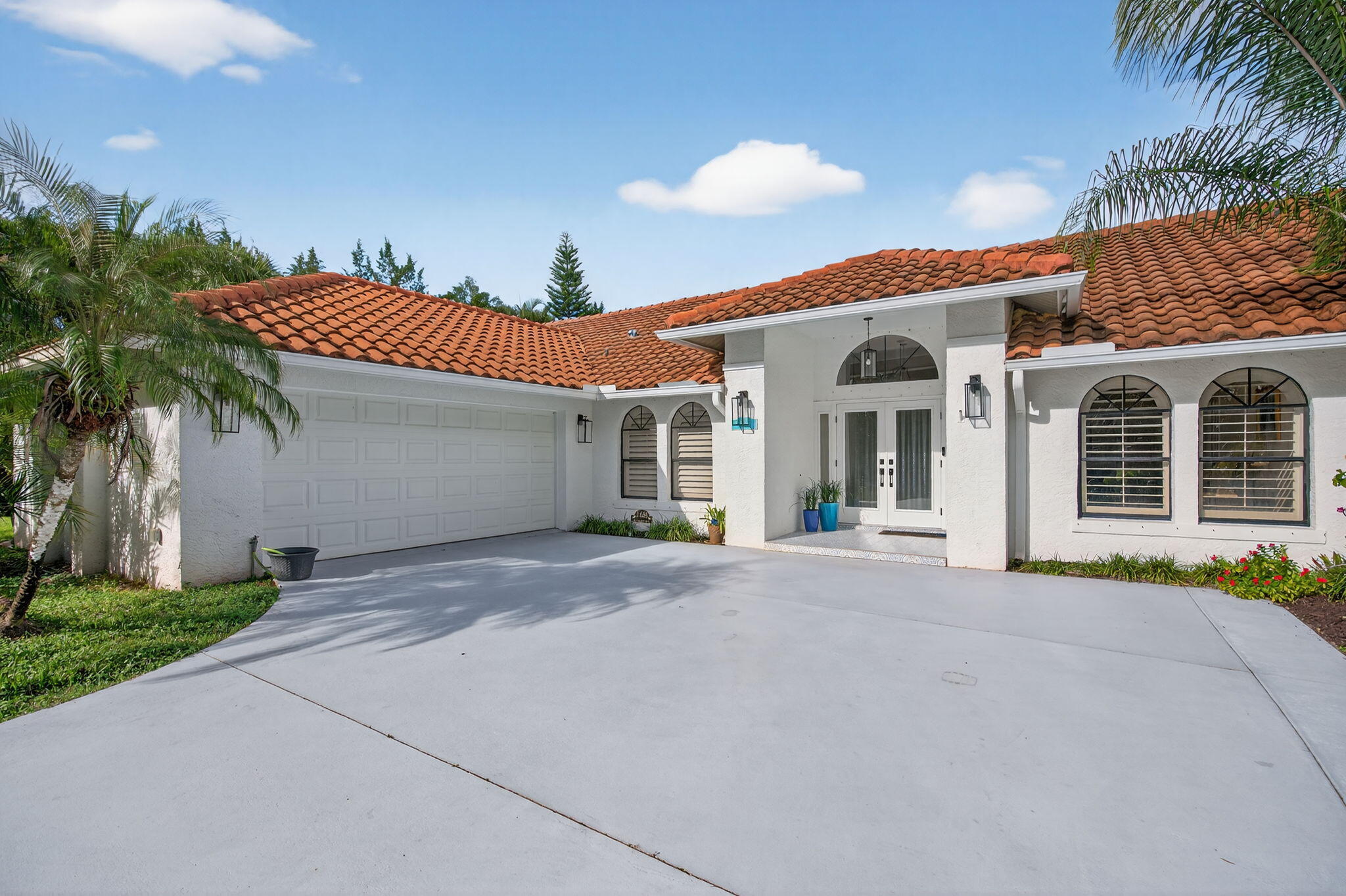 1488 Southeast Colony Way Jupiter, FL 33478 - Photo 9 of 46 Front of Home-extended/widened driveway