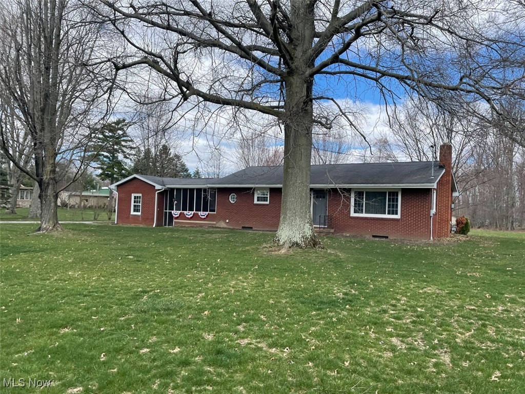 855 Georgetown Road Salem, OH 44460 - Photo 3 of 28 Front view of house with brick siding, crawl space, a chimney, and a lawn