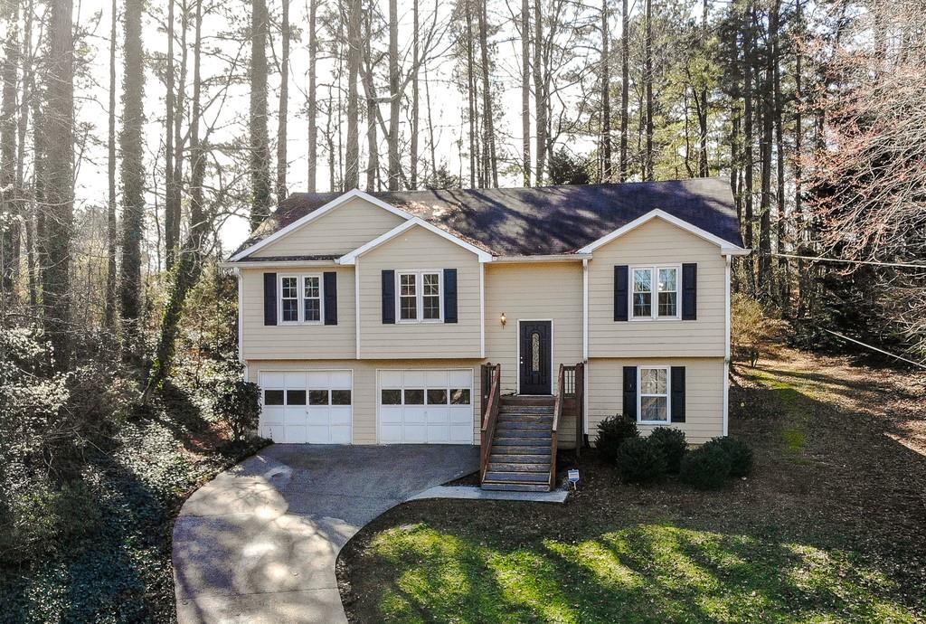 2925 Ridge Court Cumming, GA 30041 - Photo 1 of 1 a house with tall trees in the background