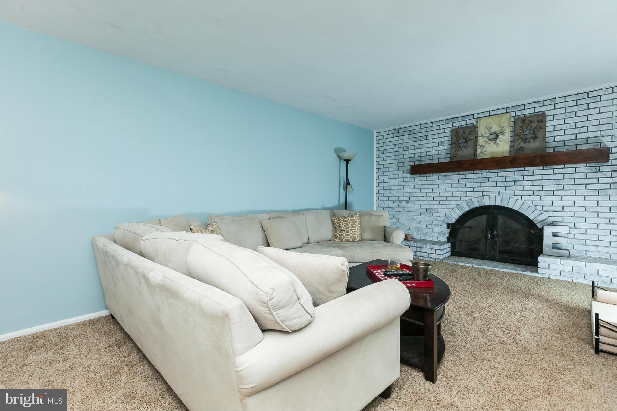 13708 Lockdale Road Silver Spring, MD 20906 - Photo 14 of 30 a living room with furniture and a fireplace