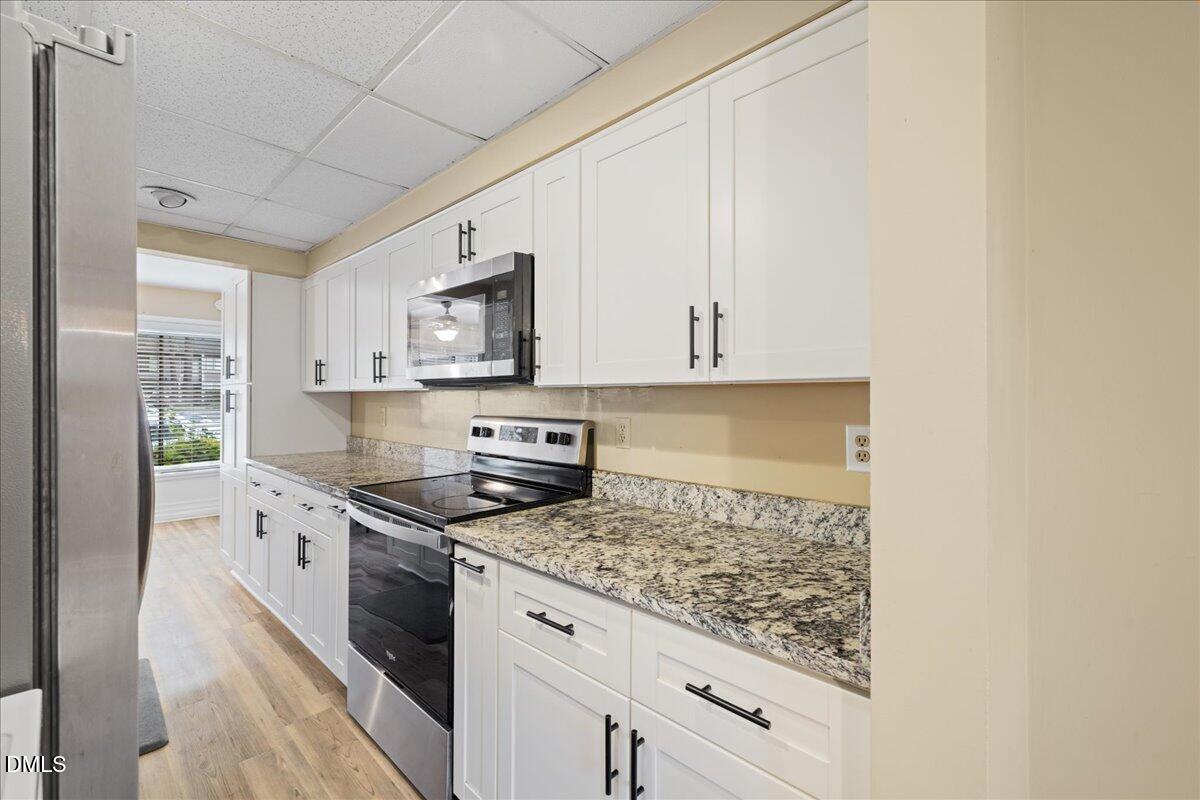 1738 Quail Ridge Road Raleigh, NC 27609 - Photo 11 of 38 a kitchen with stainless steel appliances granite countertop a stove a sink and a refrigerator