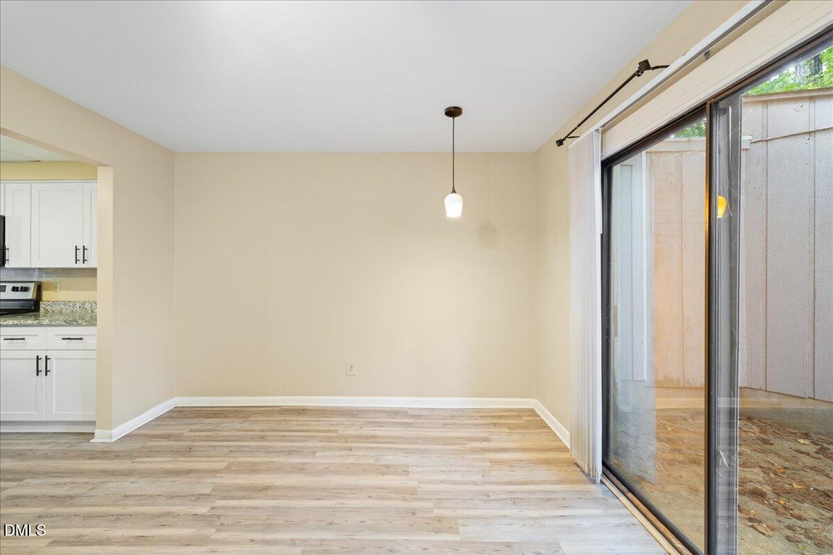 1738 Quail Ridge Road Raleigh, NC 27609 - Photo 13 of 38 a view of empty room with wooden floor and fan