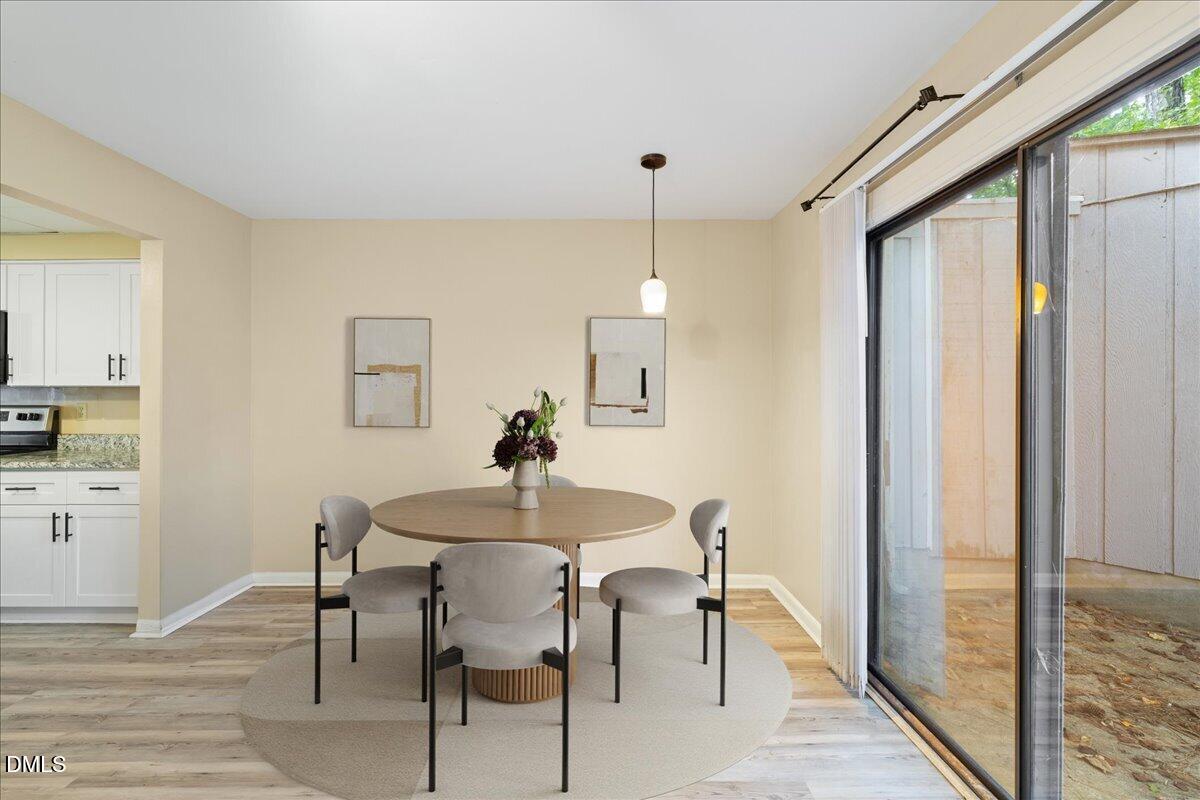 1738 Quail Ridge Road Raleigh, NC 27609 - Photo 14 of 38 a view of a a dining room with furniture window and wooden floor