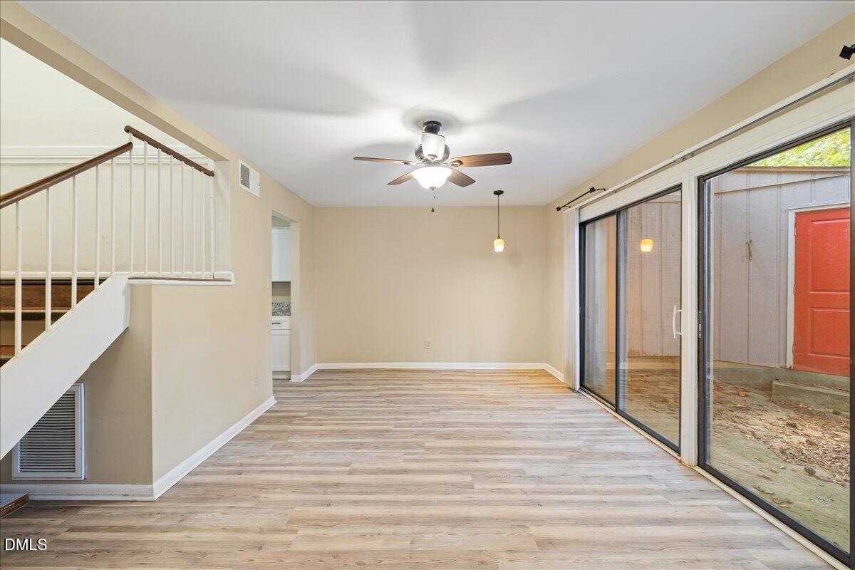 1738 Quail Ridge Road Raleigh, NC 27609 - Photo 18 of 38 a view of an empty room with wooden floor and a window