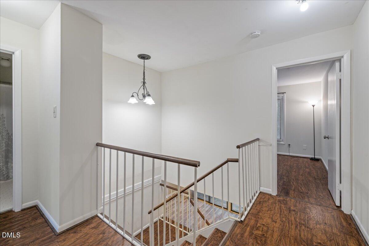 1738 Quail Ridge Road Raleigh, NC 27609 - Photo 22 of 38 a view of a hallway with wooden floor and staircase