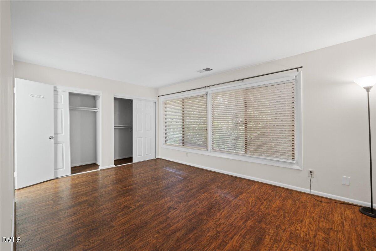 1738 Quail Ridge Road Raleigh, NC 27609 - Photo 23 of 38 a view of an empty room with wooden floor and a window