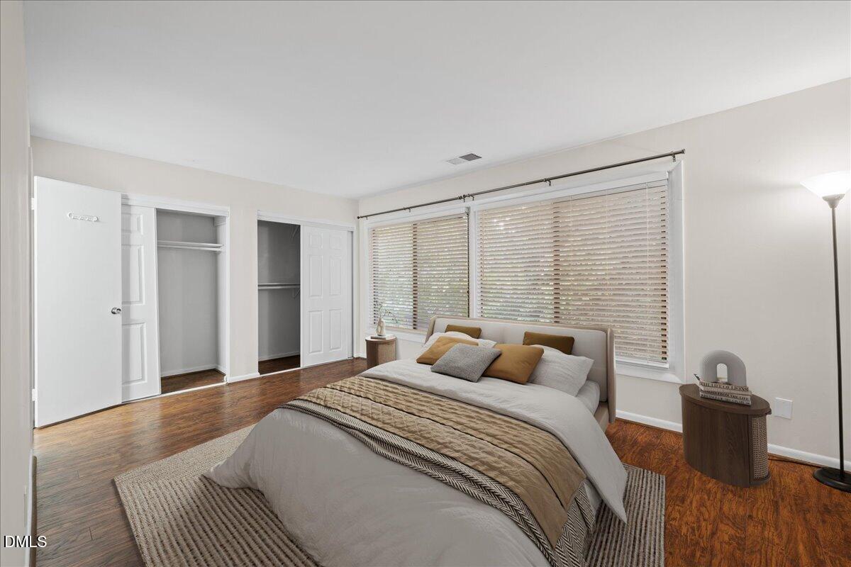 1738 Quail Ridge Road Raleigh, NC 27609 - Photo 24 of 38 a bedroom with a large bed and a wooden floor