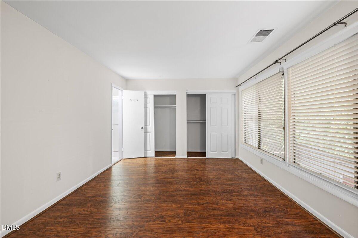 1738 Quail Ridge Road Raleigh, NC 27609 - Photo 25 of 38 a view of an empty room with a window and wooden floor