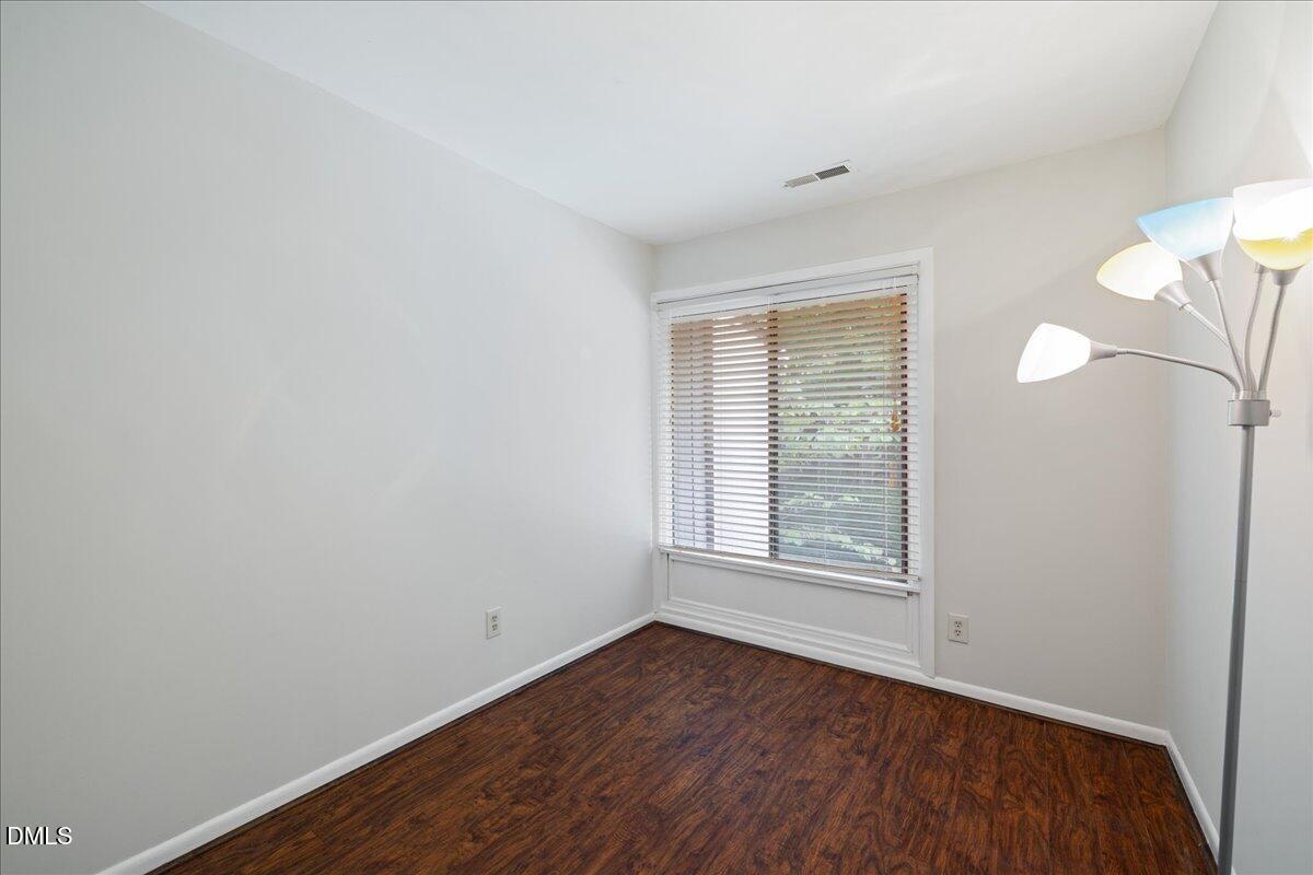 1738 Quail Ridge Road Raleigh, NC 27609 - Photo 30 of 38 an empty room with wooden floor and windows